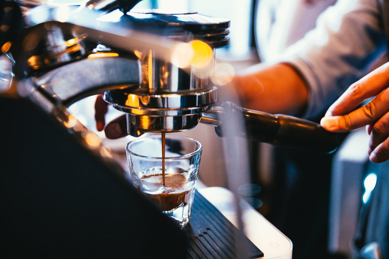 Business owner receiving expert advice on choosing the right commercial coffee machine from a StafCo specialist.