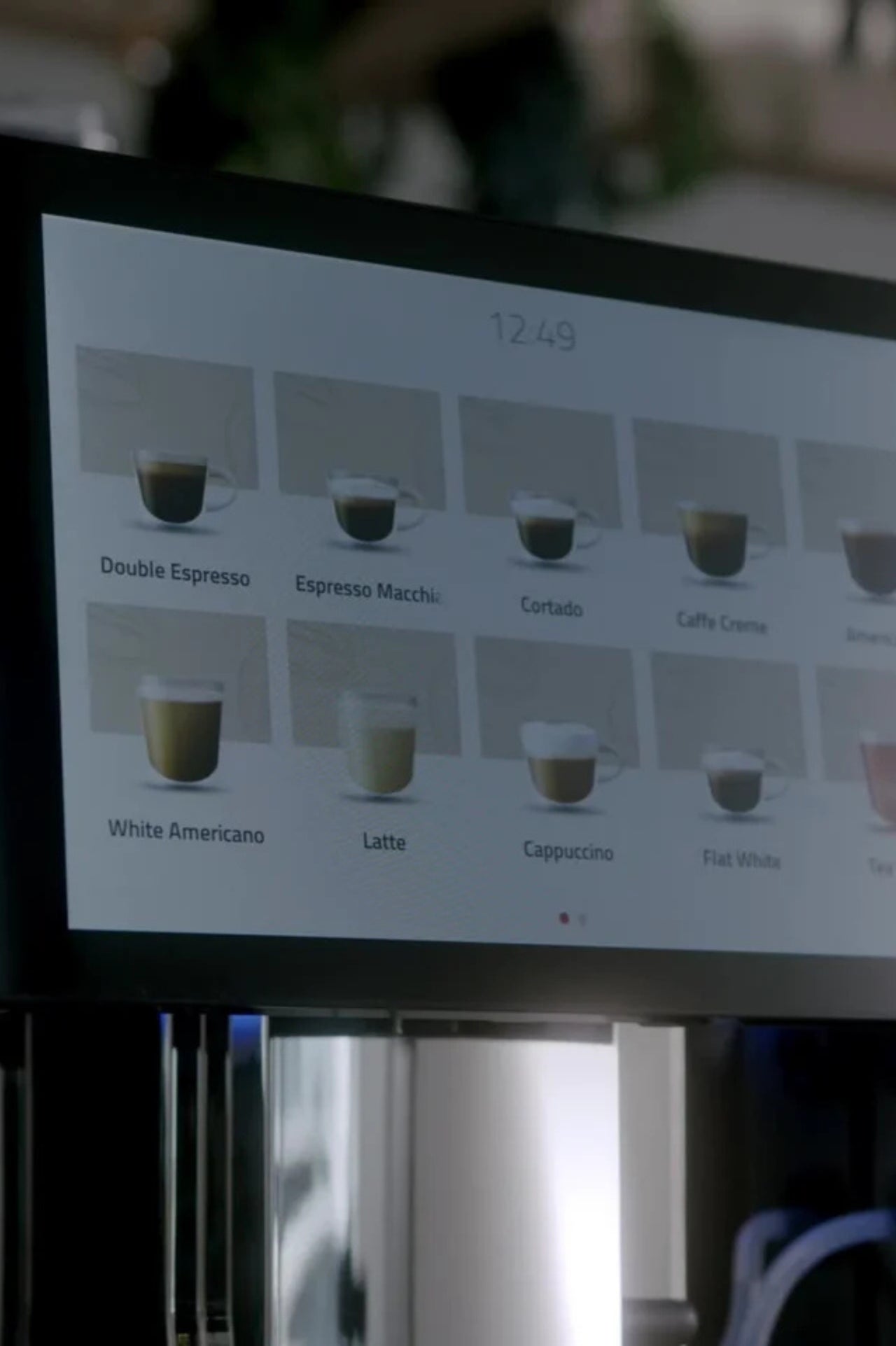 A commercial fresh milk bean-to-cup coffee machine with adjacent refrigerated fresh milk to prepare drinks automatically